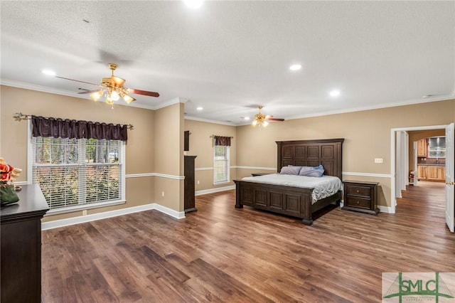 bedroom featuring a textured ceiling, dark hardwood / wood-style flooring, multiple windows, and ornamental molding