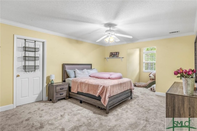 bedroom with a textured ceiling, light colored carpet, ceiling fan, and ornamental molding