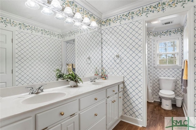 bathroom with vanity, toilet, wood-type flooring, and ornamental molding