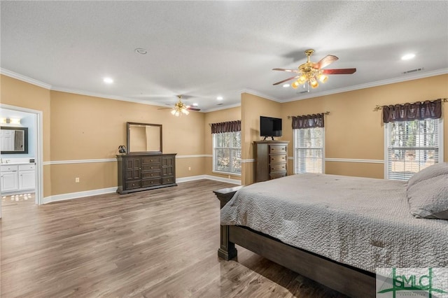 bedroom with connected bathroom, ceiling fan, hardwood / wood-style floors, and crown molding