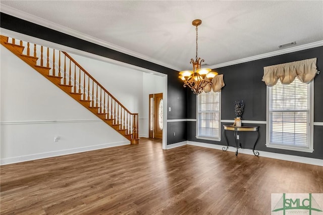 unfurnished dining area with hardwood / wood-style flooring, a chandelier, and ornamental molding