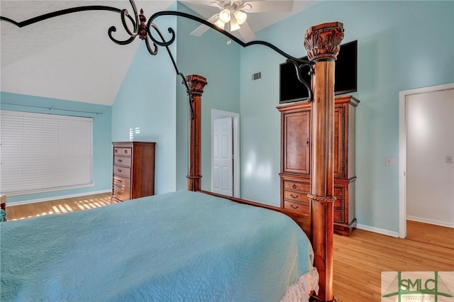 bedroom with ceiling fan, light wood-type flooring, and lofted ceiling