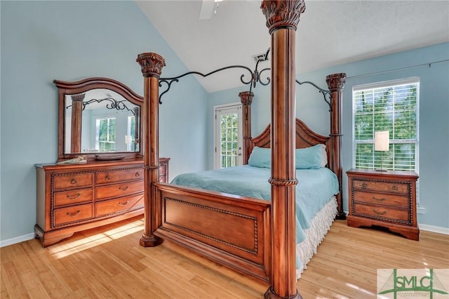 bedroom with multiple windows, ceiling fan, light hardwood / wood-style flooring, and lofted ceiling