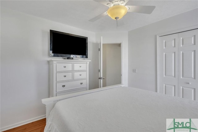 bedroom with wood-type flooring, a closet, and ceiling fan