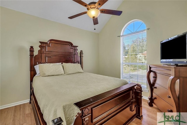 bedroom featuring light hardwood / wood-style flooring, vaulted ceiling, and ceiling fan