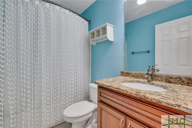 bathroom with vanity, toilet, and walk in shower