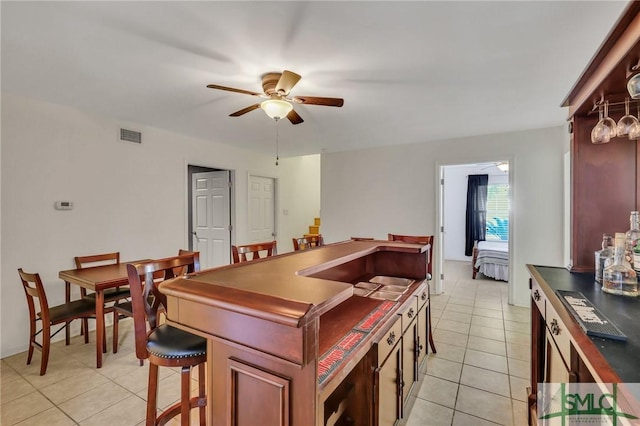 kitchen with ceiling fan and light tile patterned floors