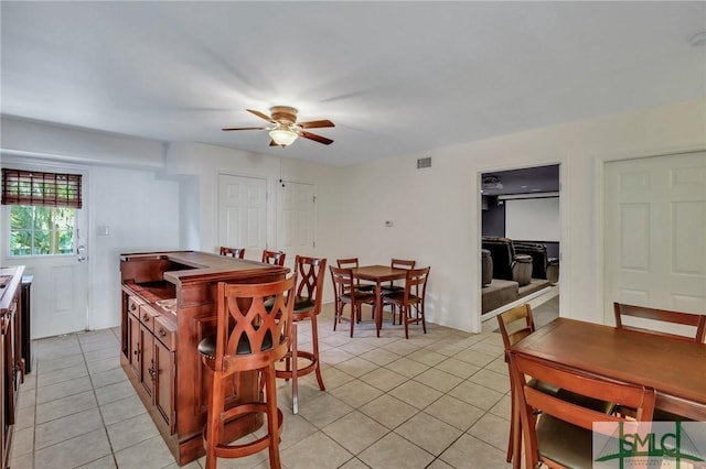 tiled dining area with ceiling fan