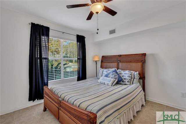 tiled bedroom featuring ceiling fan