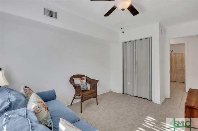 living area featuring ceiling fan and light tile patterned floors