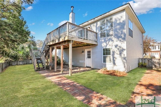 back of property featuring a yard and a wooden deck