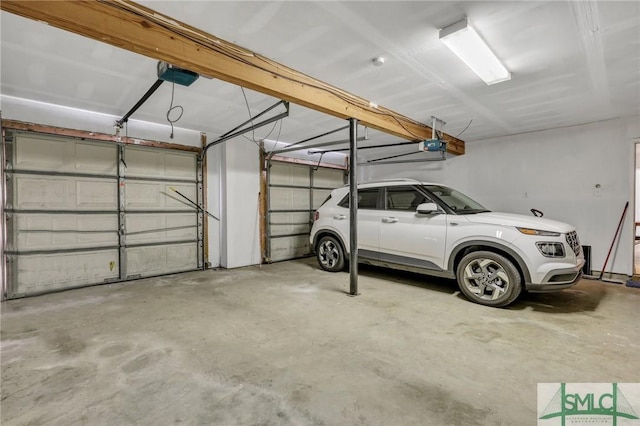 garage featuring a garage door opener and a carport