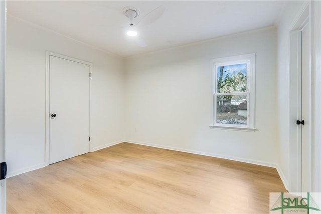 empty room featuring ornamental molding and light hardwood / wood-style flooring