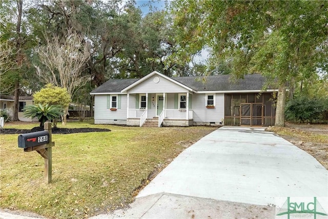 ranch-style house with a front lawn, a sunroom, and a porch