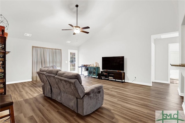 living room featuring dark hardwood / wood-style flooring, high vaulted ceiling, and ceiling fan