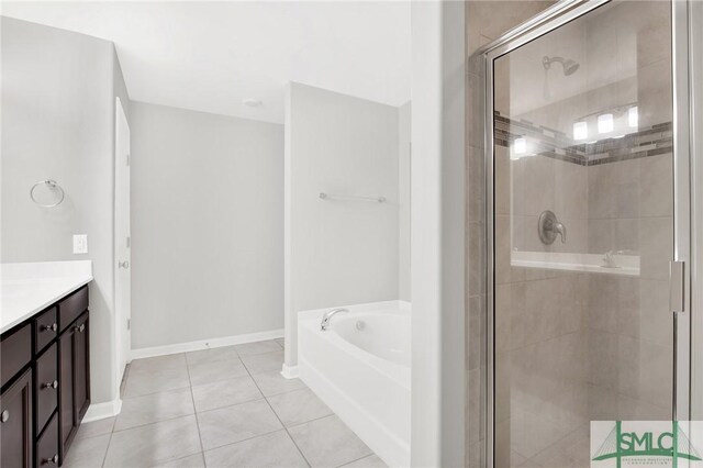 bathroom with tile patterned flooring, vanity, and shower with separate bathtub