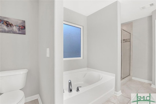 bathroom featuring tile patterned floors, separate shower and tub, and toilet