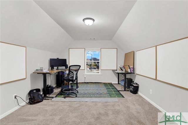 carpeted office space with lofted ceiling