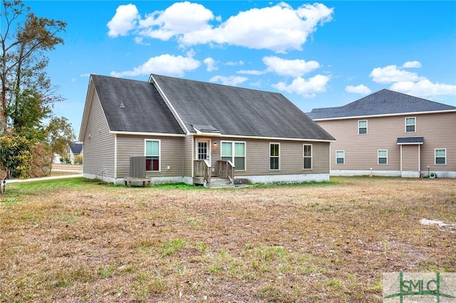 rear view of house with a yard