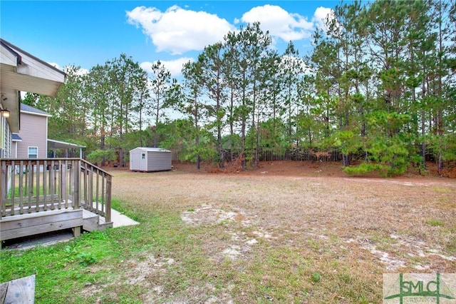 view of yard with a shed and a wooden deck