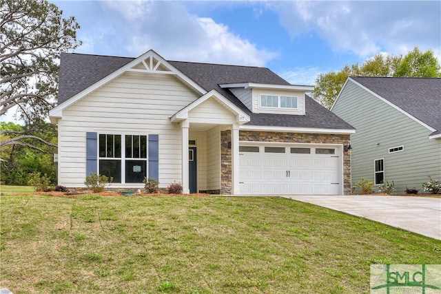 craftsman-style house featuring a front yard and a garage