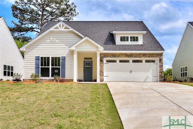 craftsman-style house featuring a garage and a front yard