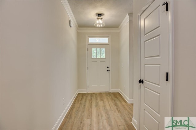 entryway featuring crown molding and light wood-type flooring