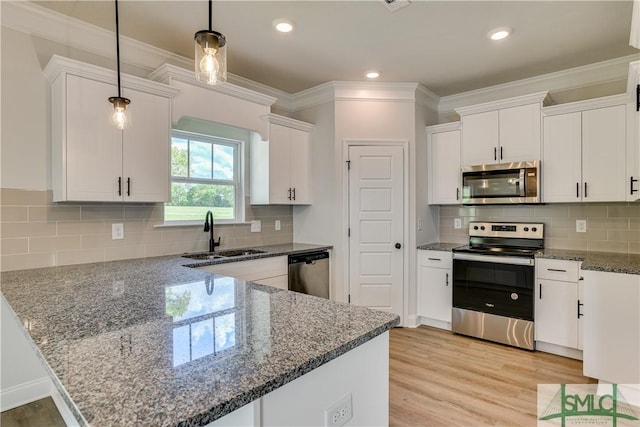 kitchen featuring white cabinetry, sink, pendant lighting, and appliances with stainless steel finishes