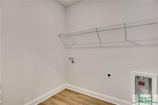 washroom with hardwood / wood-style floors, hookup for a washing machine, and electric dryer hookup