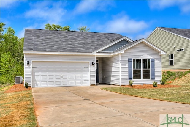 view of front of home with central AC unit, a garage, and a front yard