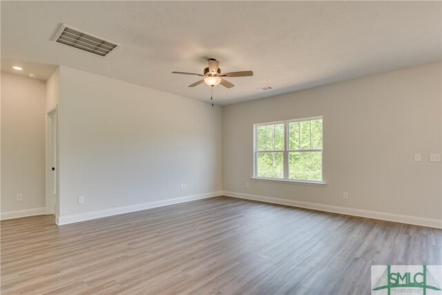 empty room featuring ceiling fan and light hardwood / wood-style flooring