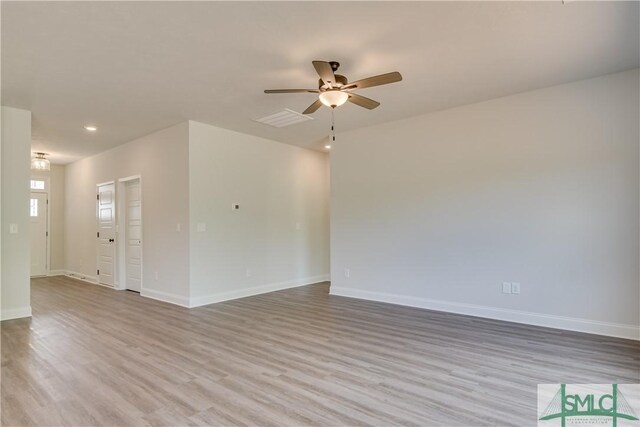 spare room featuring ceiling fan and light hardwood / wood-style flooring