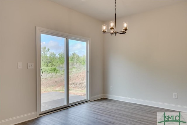 interior space featuring wood-type flooring, an inviting chandelier, and a wealth of natural light