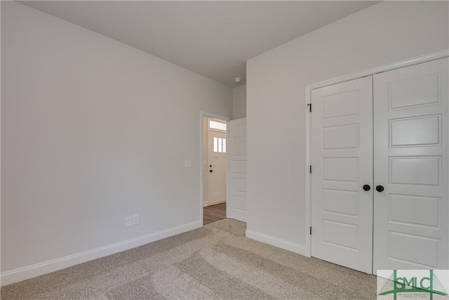 unfurnished bedroom featuring carpet and a closet