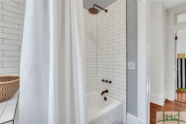 bathroom featuring shower / bathtub combination with curtain and hardwood / wood-style flooring