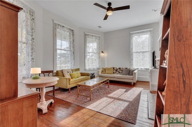 living area featuring ceiling fan and hardwood / wood-style floors