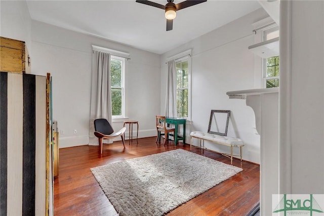 living area featuring ceiling fan and hardwood / wood-style flooring