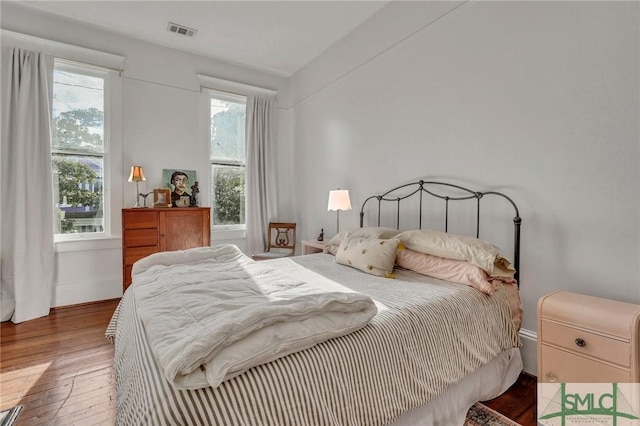 bedroom with hardwood / wood-style flooring