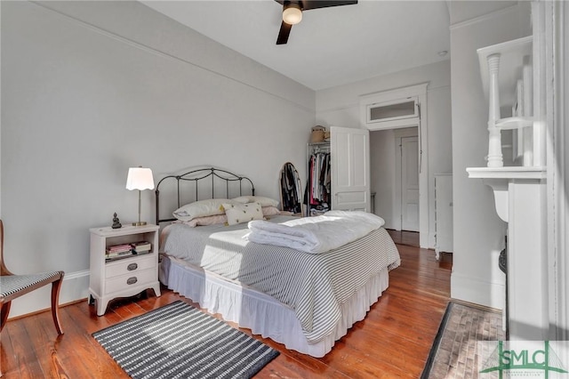 bedroom featuring hardwood / wood-style flooring, ceiling fan, and a closet