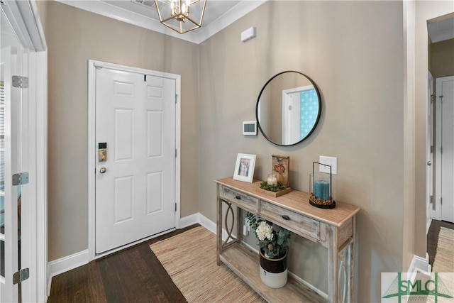 foyer entrance with hardwood / wood-style flooring, a notable chandelier, and ornamental molding