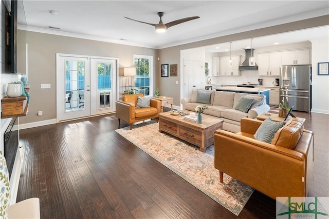 living room with ceiling fan, dark hardwood / wood-style flooring, crown molding, and french doors