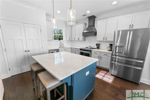 kitchen with dark hardwood / wood-style flooring, premium range hood, pendant lighting, a kitchen island, and appliances with stainless steel finishes