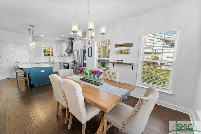 dining space featuring ornamental molding, dark wood-type flooring, a healthy amount of sunlight, and a notable chandelier