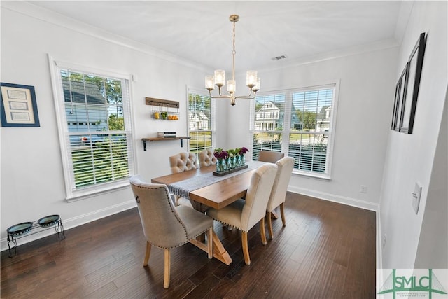 dining area with a notable chandelier, dark hardwood / wood-style flooring, and ornamental molding