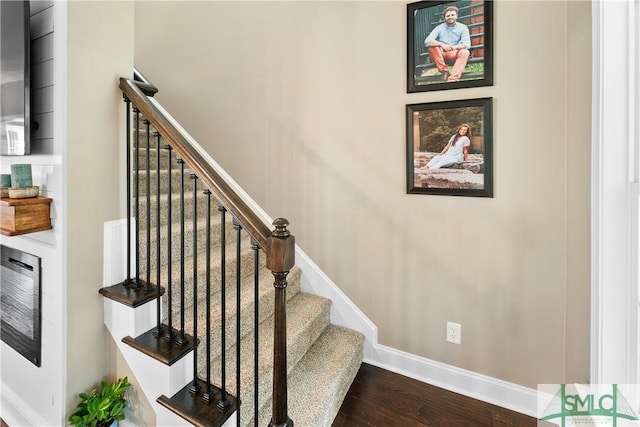 staircase with wood-type flooring