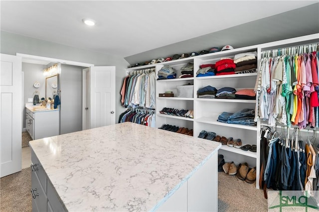 spacious closet featuring light carpet