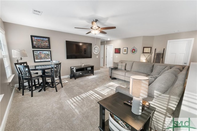 living room with light carpet and ceiling fan