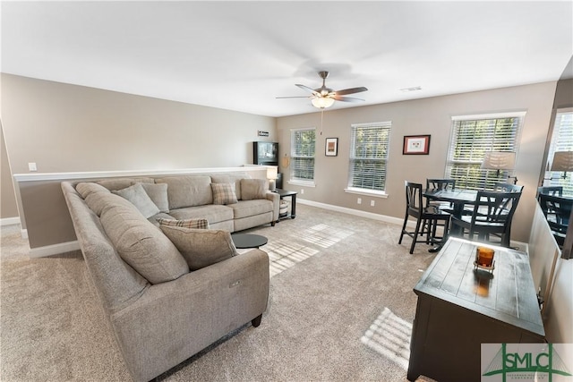 living room with light carpet and ceiling fan