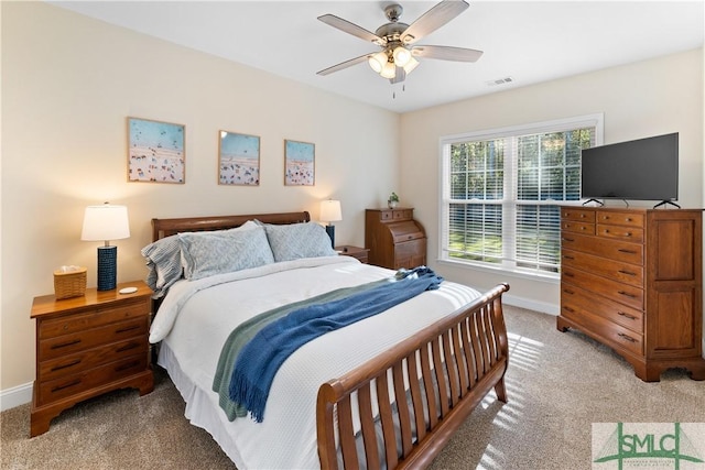 bedroom featuring ceiling fan and light carpet