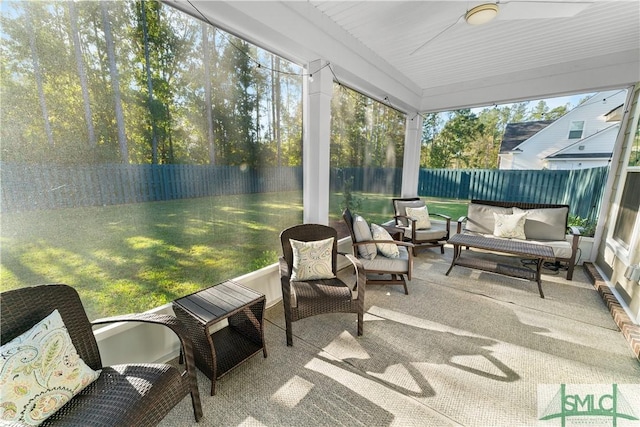 sunroom / solarium featuring ceiling fan